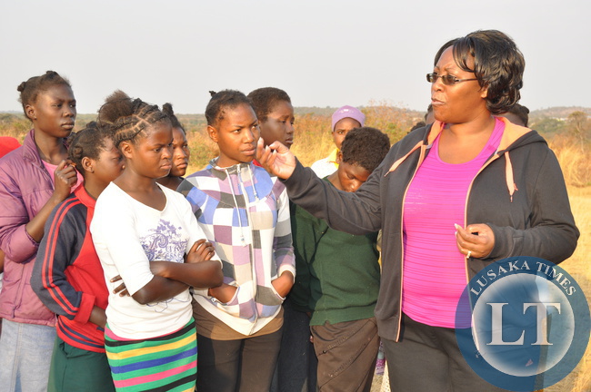 First Lady Dr Christine Kaseba with Pupils after the Physical education Session at the just ended First Lady's Mentorship training of Teachers/ Community Leaders and Pupils at Chinsali Girls Secondary school grounds on August 15, 2014 -Picture by THOMAS NSAMA
