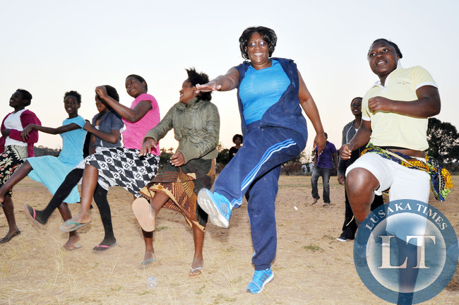 First Lady Dr Christine Kaseba with Pupils during the Physical education Session at the on-going First Lady's Mentorship training of Teachers/ Community Leaders and Pupils at Chinsali Girls Secondary school grounds on August 14, 2014 -Picture by THOMAS NSAMA