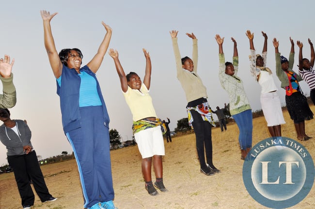 First Lady Dr Christine Kaseba with Pupils during the Physical education Session at the on-going First Lady's Mentorship training of Teachers/ Community Leaders and Pupils at Chinsali Girls Secondary school grounds on August 14, 2014 -Picture by THOMAS NSAMA