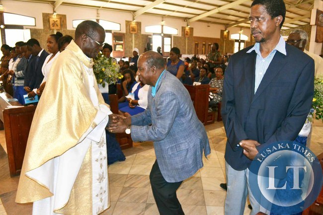 Finance Minister Alexander Chikwanda (centre) shakes hands with Archbishop of Lusaka Telesphore Mpundu (left) as Defence Minister Edgar Lungu looks on at the memorial service of the late Benjamin Mwila at the Cathedral of the Child Jesus in Lusaka