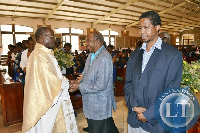 Finance Minister Alexander Chikwanda (centre) shakes hands with Archbishop of Lusaka Telesphore Mpundu (left) as Defence Minister Edgar Lungu looks on at the memorial service of the late Benjamin Mwila at the Cathedral of the Child Jesus in Lusaka
