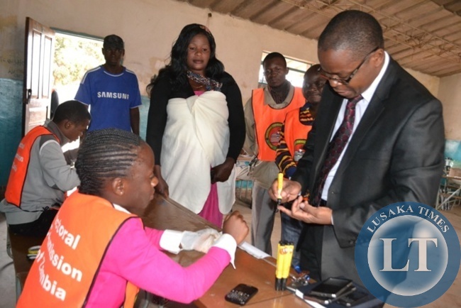 SOLWEZI District Electoral Officer Ronald Daka conducting a check on the quality of voting materials at Kyawama Polling Station during Solwezi Central by-elections