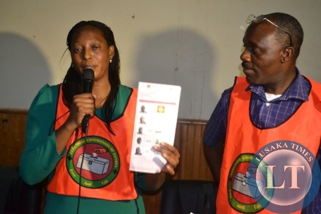 SOLWEZI Central constituency returning officer Sera Lunda displaying mistakenly disputed ballot paper at the totaling centre on Thursday night