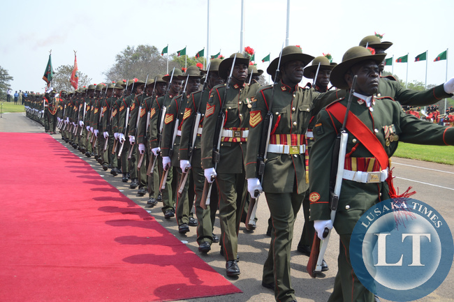 Military personnel march past President Michael Sata (not in picture) at the official opening of Parliament.