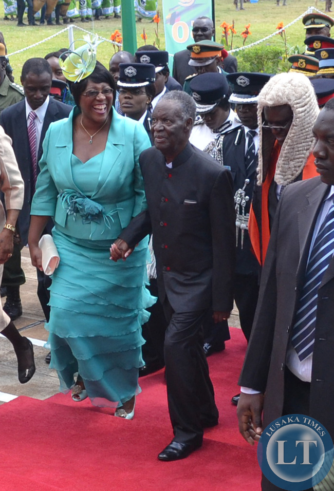 President Michael Sata walks hand in hand with First Lady Christine Kaseba (left) as Speaker of the National assembly Patrick Matibini (right) looks on when he arrived at Parliament grounds