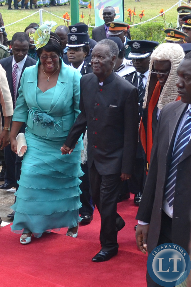 President Michael Sata walks hand in hand with First Lady Christine Kaseba (left) as Speaker of the National assembly Patrick Matibini (right) looks on when he arrived at Parliament grounds