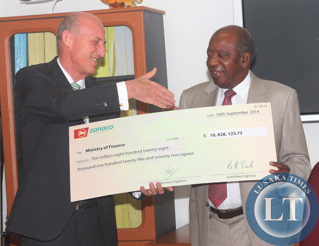 Zambia Minister of Finance Alexander Chikwanda receives a cheque worth of K10 million Eight Hundred Twenty Eight from Zanaco MD Dick Bruce as a 2013 Divedend Payment to Zambia Government; the ceremony took place at the Ministry Boardroom in Lusaka.