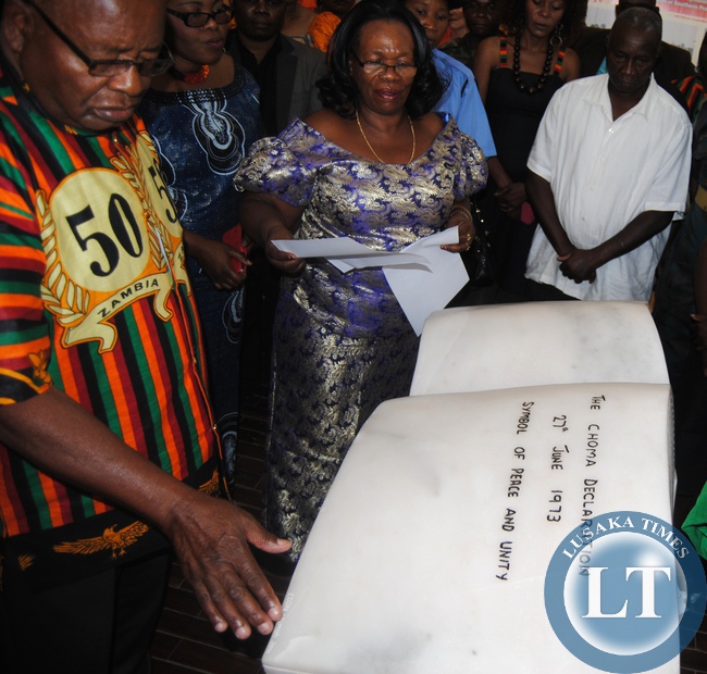 CHIEFS and Traditional Affairs Minister Nkandu Luo reads a statement on behalf of first republican President Kenneth Kaunda as Southern Province Minister Daniel Munkombwe (left), Choma Museum executive director Bevin Sangulube and Patriotic Front Choma District chairperson Felix Chilufya (in white shirt) listen during commemoration of the Choma Declaration of 1973 at the Museum
