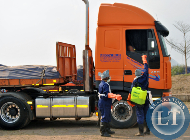 HEALTH workers disinfectant a foreign truck before removing the body of a Zimbabwean driver China Maduma who was found dead after parking for a rest in Choma HEALTH workers disinfectant a foreign truck before removing the body of a Zimbabwean driver China Maduma who was found dead after parking for a rest in Choma
