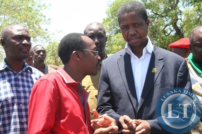 Defense Minister Edgar Lungu (r) who is also PF Secretary General listens to PF Director of Media and Publicity Brian Hapunda (c) after a closed door meeting with the Litunga at the Royal Palace in Limulunga District during the tour of duty of Western Province