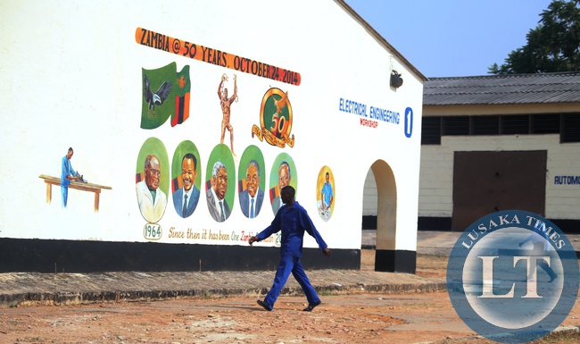 AS Zambia's jubilee celebrations nears, preparations are now seen everywhere. Here, a man passing by paintings at Mansa Trades Training Institute.