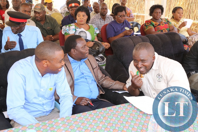 Chongwe District Commissioner Kebby Kashimamilonda confers with Lusaka Province Minister Philip Kosamu while Deputy PS Bright Nundwe looks on during the Zambangulwe Traditional Ceremony of His Royal Highness Chief Chipepo of Chirundu District