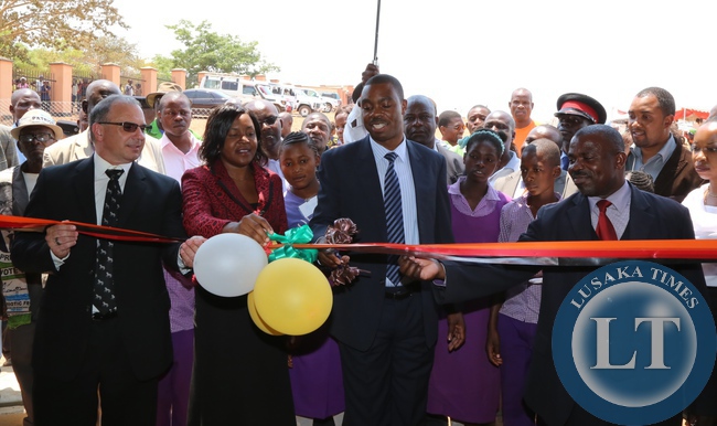 Lusaka Province Minister Phillip Kosam cutting the ribbon during the official opening of village of hope health post in chongwe district