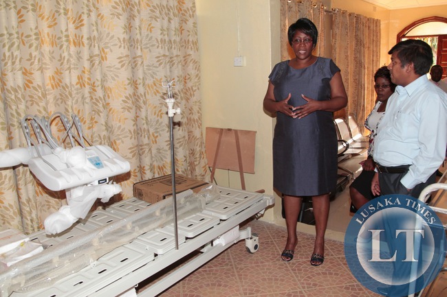 First Lady Dr Christine Kaseba Sata talks to r Mr Shreekrshna Gupta the Managing director of Asian medicos enterprise when she toured the company