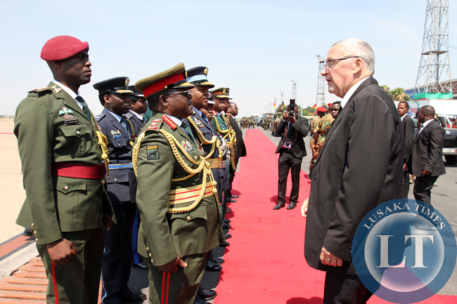 Dr Guy Scott acting President of Zambia talks to Defence Commanders at KK international airport while waiting for the late President body