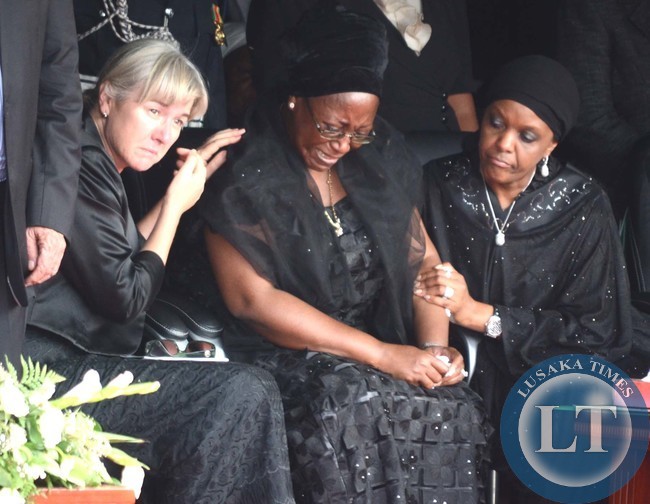 FIRST Lady Christine Kaseba Sata being consoled by Zimbabwean First Lady Amai Grace Mugabe (right) and wife of acting President Guy Scott, Charlotte,