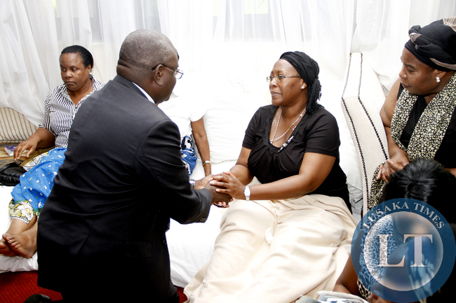 welcomed by Dr Charlotte Scott before signing in the book of condolences opened at the Government House