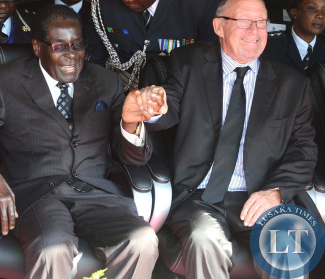 Mugabe, Dr Scott share a light moment