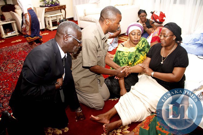 First Lady Dr Kaseba being comforted by Lusaka deputy minister Philip Kosamu as Agriculture and livestock Permanent Secretary Dr David Shamulenge looks on at the house of mourning of President Sata at State House on Nov 3,2014 -Picture by THOMAS NSAMA