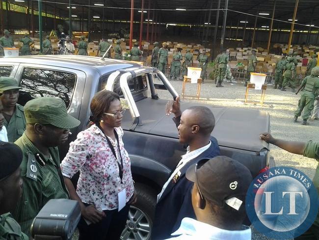 PF chairperson for elections, Syliva Masebo, with armed police, insisting that the planned elections are illegal