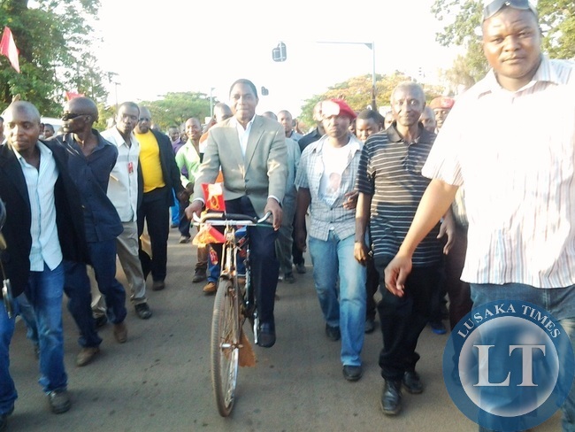UPND President Hakainde Hichilema cycling a bicycle along Umodzi Highway in Chipata