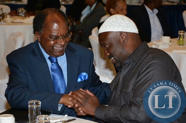 Bank of Zambia Governor Michael Gondwe having the light moment with Islamic Supreme Council President Suzgo Zimba during the launch of Islamic Finance guideline