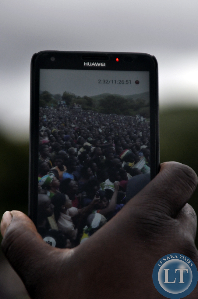 A resident of Chiapata records footage of the joint rally for former president Rupiah Banda and Edgar Lungu.