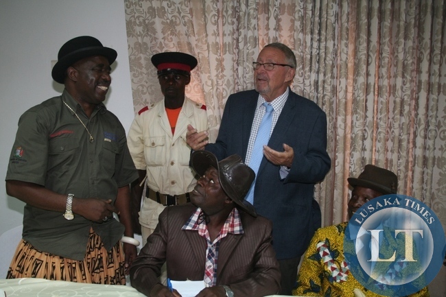 Acting President Guy Scott chats with chief Mumena (l) during the meeting with Solwezi based traditional leaders at Solwezi Lodge on Thursday in Solwezi as chief Matebo (r ) looks on.