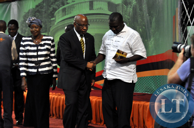 Dr Nevers Mumba with his advisor Raphael Nakachinda (r) during break at the presidential debate