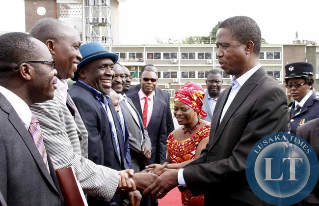 President Edgar Lungu greets Goodward Mulubwa as his Special Assistant for Political Affairs Kaiza Zulu looks on on arrival at Kenneth Kaunda International Airport shortly before departure to Addis Ababa, Ethiopia for the African Union Summit on January 29,2015 -Picture by THOMAS NSAMA