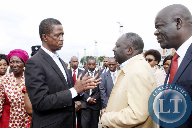 President Edgar Lungu talks to PF Secretary General Davies Chama as Home Affairs minister Davies Mwila (r) looks on at Kenneth Kaunda International Airport shortly before departure to Addis Ababa, Ethiopia for the African Union Summit on January 29,2015 -Picture by THOMAS NSAMA