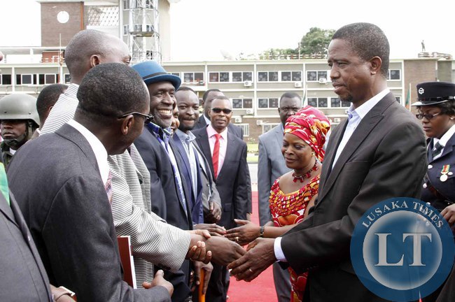 President Edgar Lungu greets Goodward Mulumbwa as his Special Assistant for Political Affairs Kaiza Zulu looks on on arrival at Kenneth Kaunda International Airport shortly before departure to Addis Ababa, Ethiopia for the African Union Summit on January 29,2015 -Picture by THOMAS NSAMA