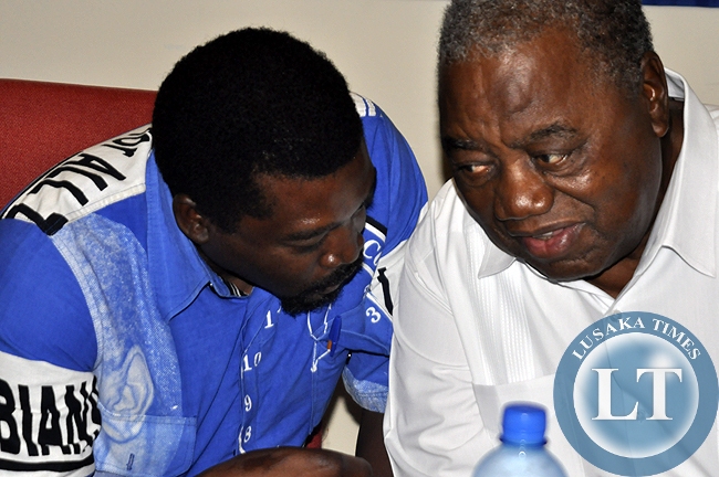 Rupiah Banda confers with Muhabi Lungu during the press conference where the former president announced his support for Edgar Lungu in the January elections.