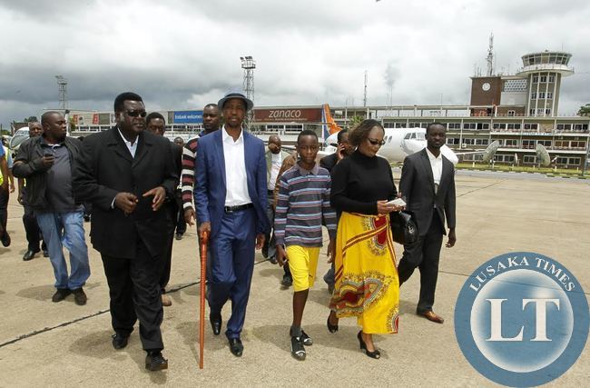 Patriotic Front (PF) President,Hon.Edgar Chagwa Lungu (second right) being escorted by his Campaign Manager Willie Nsanda (left) and Mumbi Phiri (right) before leaving Kenneth Kaunda International Airport on his way to Luapula Province for campaigns on Saturday,January 10,2015.PICTURE BY SALIM HENRY/SHENPA