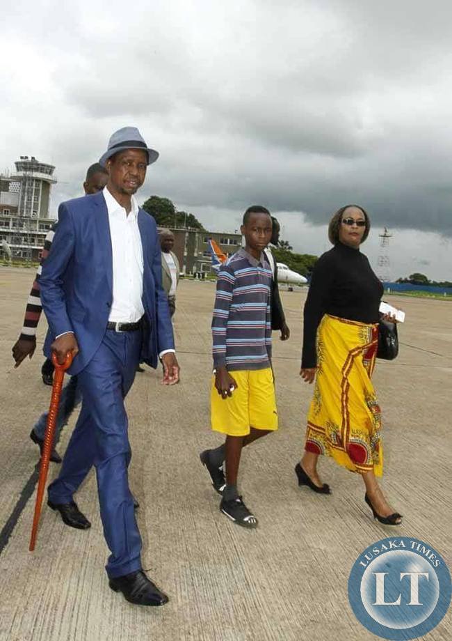 Patriotic Front (PF) President,Hon.Edgar Chagwa Lungu (second right) being escorted by his Campaign Manager Willie Nsanda (left) and Mumbi Phiri (right) before leaving Kenneth Kaunda International Airport on his way to Luapula Province for campaigns on Saturday,January 10,2015.PICTURE BY SALIM HENRY/SHENPA