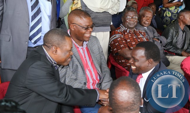 Lusaka Province Deputy Permanent Secretary Bright Nundwe confers with Rainbow Party President Wynter Kabimba during the burial of the late former Chongwe District Commisioner Charles Mwambi at memorial park