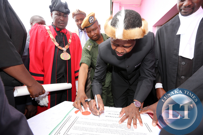 President Edgar Lungu signs a Roll at Honourary Freeman of the Chipata Municipality at Civic Centre, Looking is town Clerk Davies Musenge and mayor Mr Jealous Phiri on Friday 27-02-2015. PICTURE BY EDDIE MWANALEZA/STATEHOUSE.