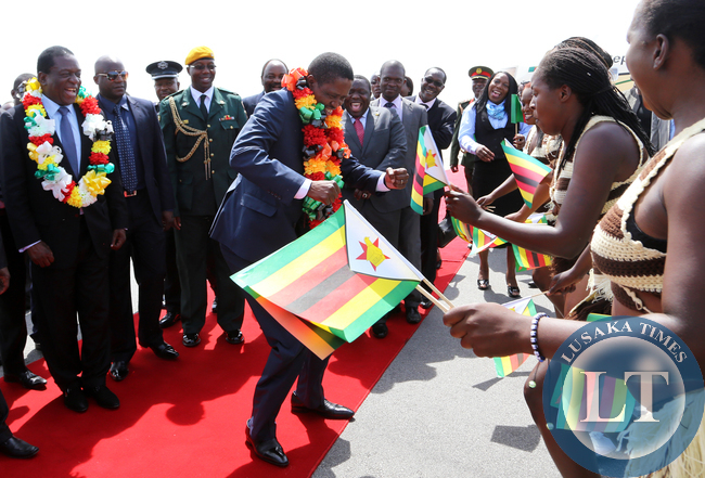 President Edgar Lungu joins in the dance looking on is Zimbabwean vice President Minister Emmerson Mnangagwa at Harare, Zimbabwe. Picture By EDDIE MWANALEZA /STATEHOUSE