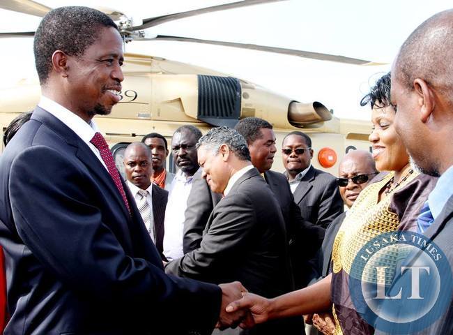 President Lungu talks greets Lands minister Christabel Ngimbu shortly before departure at Kenneth Kaunda International Airport for Angola on February 13,2015 -Picture by THOMAS NSAMA