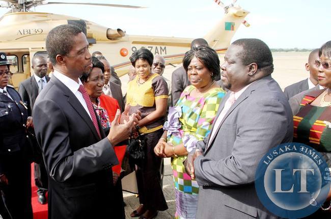 President Lungu talks Information minister Chishimba Kambwili shortly before departure at Kenneth Kaunda International Airport for Angola on February 13,2015 -Picture by THOMAS NSAMA