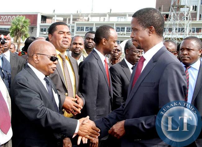 President Lungu greets Local government and Housing minister John Phiri shortly before departure at Kenneth Kaunda International Airport for Angola on February 13,2015 -Picture by THOMAS NSAMA