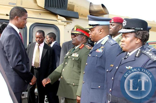 President Lungu talks to Zambia army commander Lt Gen Paul Mihova as ZAF Commander Lt Gen Eric Chimese and Inspector General of Police Stella Libongani looks on shortly before departure at Kenneth Kaunda International Airport for Angola on February 13,2015 -Picture by THOMAS NSAMA