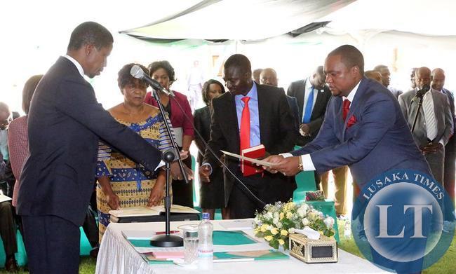 President Edgar Chagwa Lungu (left) receives an affidavit of Oath from Newly appointed Commerce Deputy minister Miles Sampa during the Swearing-In-Ceremony at State House on February