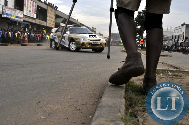 A videographer moves in position to have a vantage point for clear shots during the ZMSA national rally championship