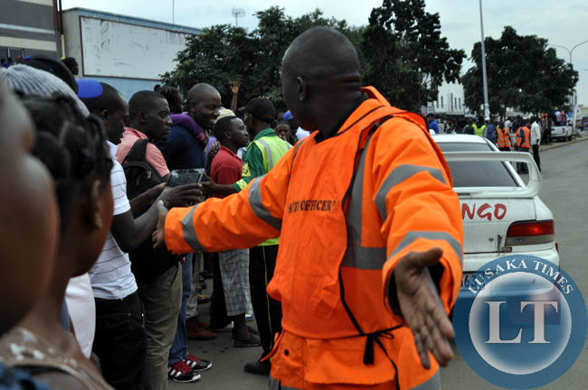 An official conducts crowd control at the rally motor event