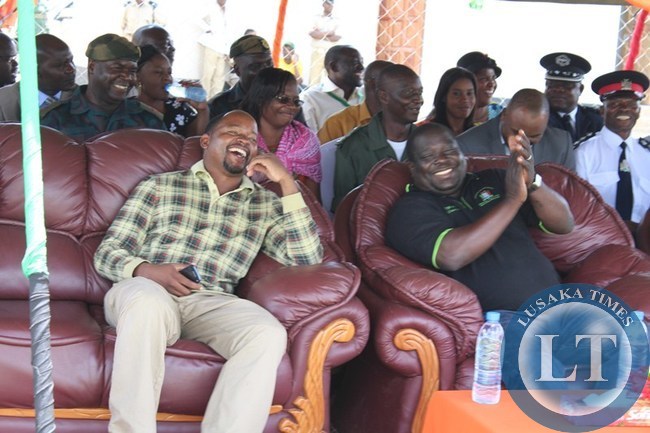 INFORMATION and Broadcasting Minister Chishimba Kambwili (r) and Choma Central Member of Parliament Conelius Mweetwa laugh and applause the dance by St. Mark’s Secondary School culture group (not in picture). This was during the Youth Day celebration at Choma stadium INFORMATION and Broadcasting Minister Chishimba Kambwili (r) and Choma Central Member of Parliament Conelius Mweetwa laugh and applause the dance by St. Mark’s Secondary School culture group (not in picture). This was during the Youth Day celebration at Choma stadium