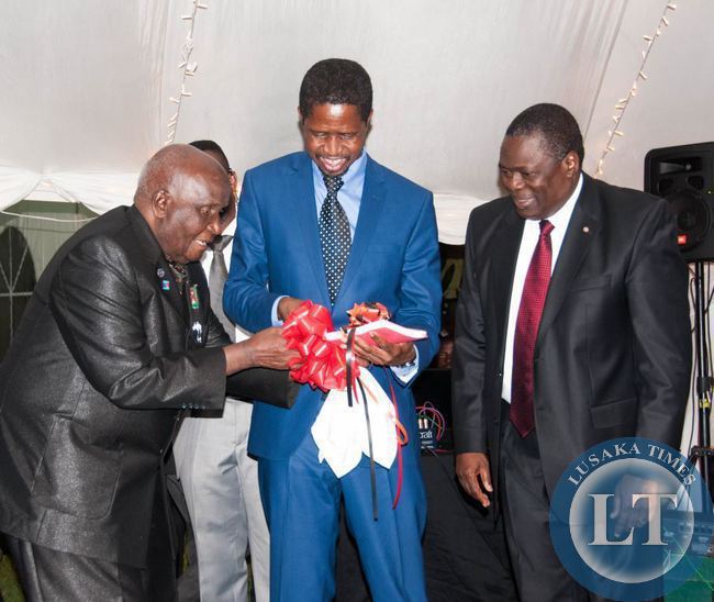 Dr Kenneth Kaunda and President Edgar Lungu admire the reprint of Dr Kaunda's book Zambia Shall Be Free, looking on is Kagem chairman William B Nyirenda