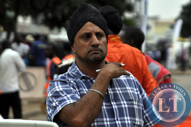 Former rally champion Muna Singh signals instructions to crew members