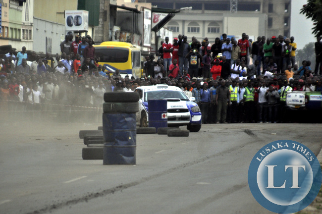 Spectators cheering one rally driver