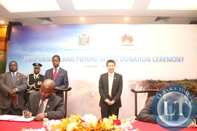 President Edgar Lungu and Huawei Senior Vice-President Dafeng Li witnessing the signing ceremony between Huawei Zambia managing director Fan Wen and Ministry of Energy representative Victor Mudenda at Shenzhen Wuzhou Guest House on April 1,2015 -Picture by THOMAS NSAMA